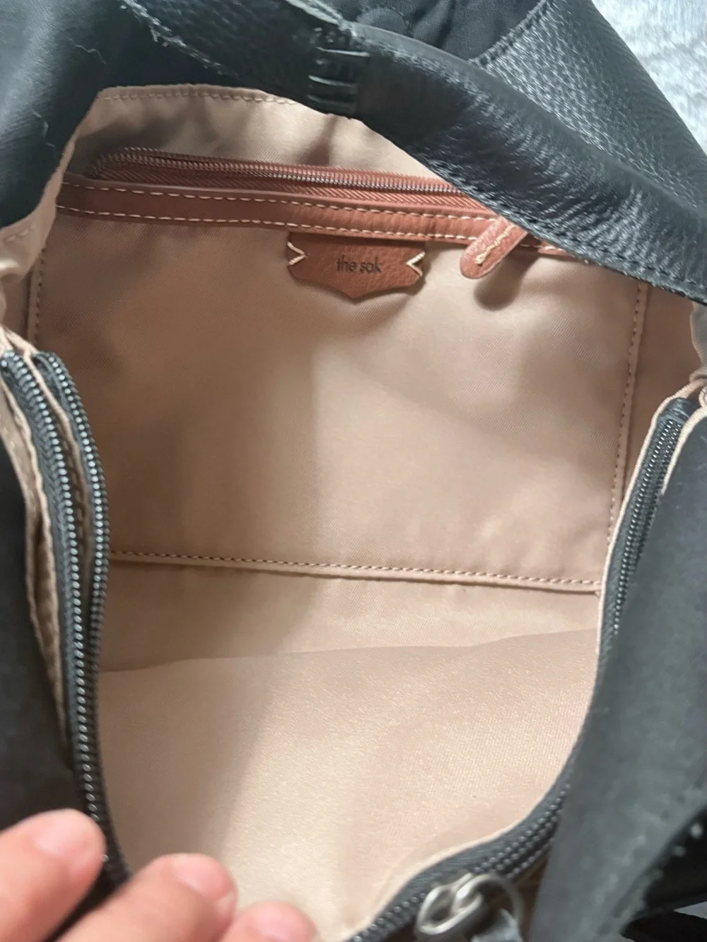 The Sak Black Leather Shoulder Bag with Tan Tassel Charm